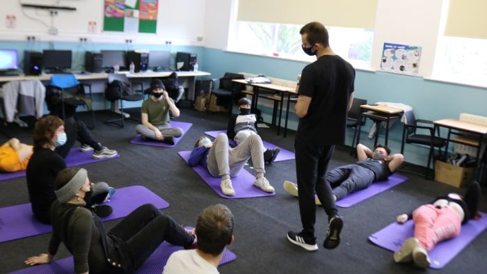 Teen participants in a Calisthenics Ireland workshop, engaging in level appropriate bodyweight training and movement drills