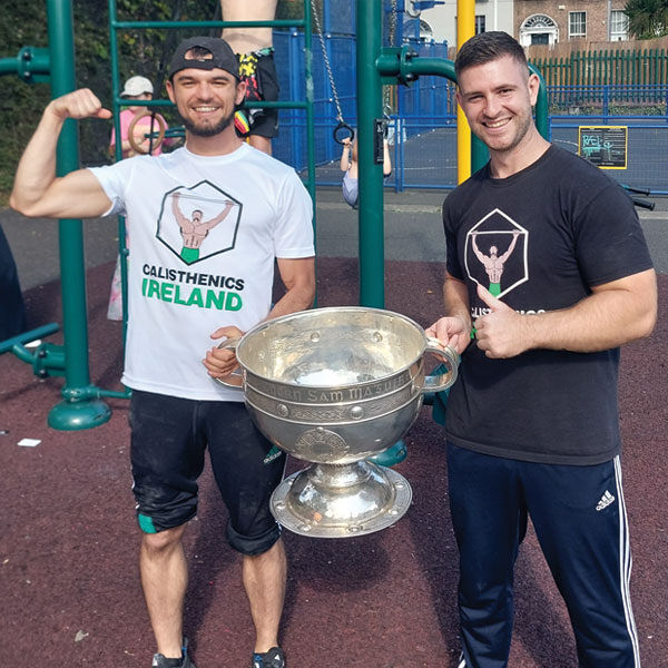 Ivan and Mikolaj from Calisthenics Ireland holding the Sam Maguire Cup at the Swellfest family event hosted by Dublin City Council and Inner City